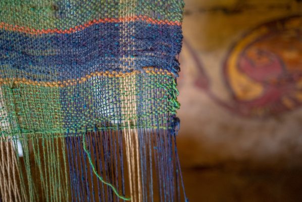 Woollen blanket in front of a primitive painting of a boar