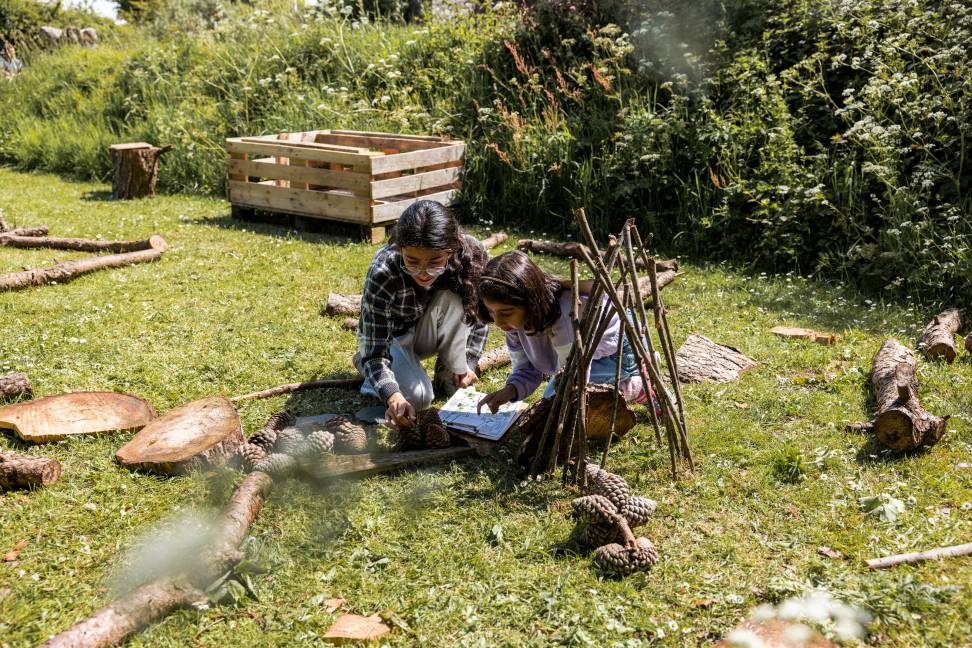 A young girl and her mum absorbed in one of Oriel y Parc's outdoor nature trails.