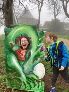 Young girl and young boy with baby dragon